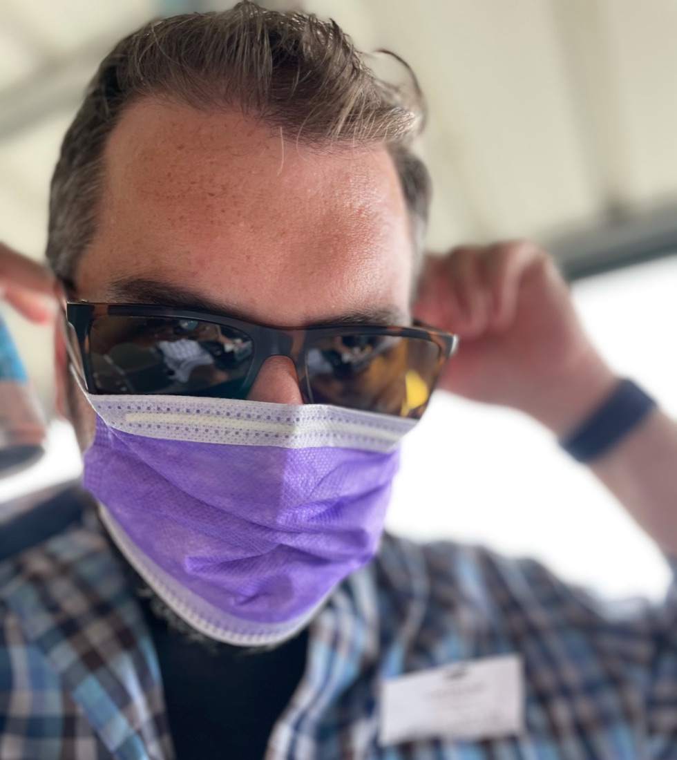 Brian Tannous in sunglasses and a purple face mask
