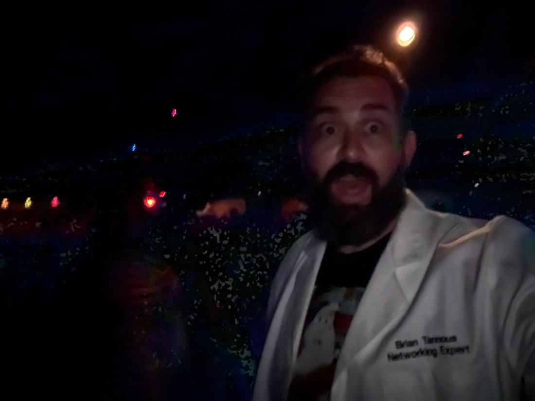 Brian Tannous at night in a lab coat embroidered Networking Expert